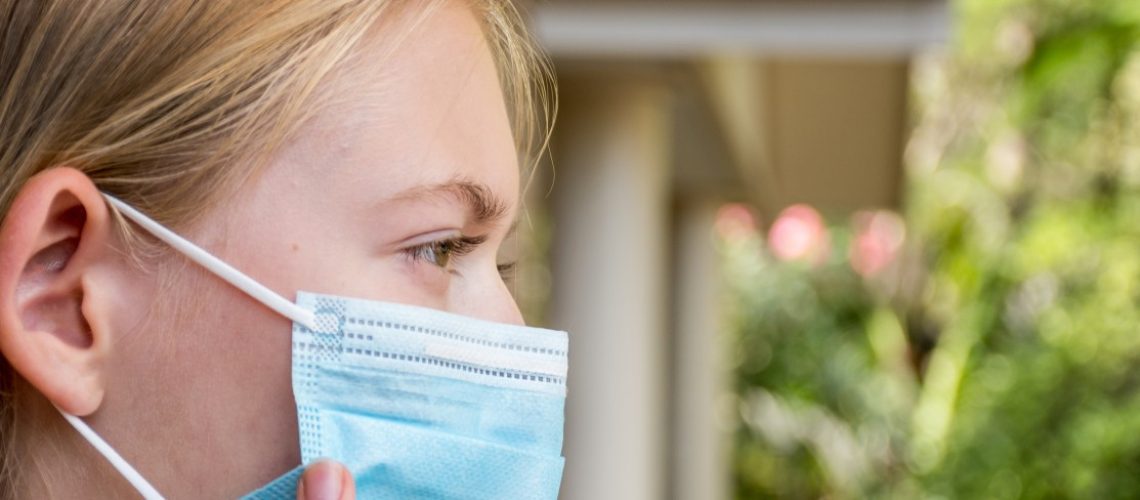 a-girl-wearing-disposable-face-mask-to-prevent-spreading-of-the-viruses-coronavirus-and-covid-19_t20_drEZKR